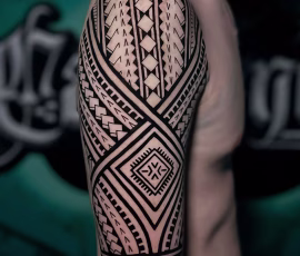 Maori-style tattoo covering the upper arm and shoulder