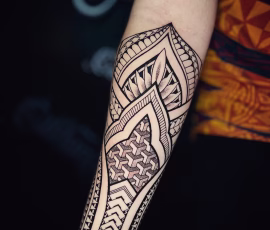 Maori-style tattoo covering the forearm with geometric patterns