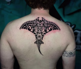 Maori-style stingray tattoo on the upper back