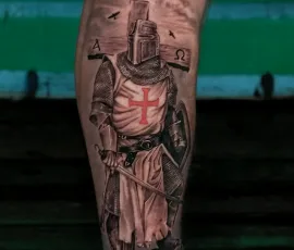 Black and grey crusader knight tattoo on a lower leg