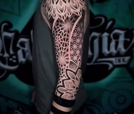 Geometric dotwork tattoo sleeve with mandala and floral patterns