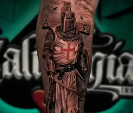Healed black and grey crusader knight tattoo on a lower leg