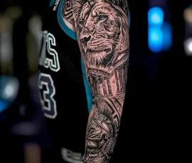 Black and grey lion realism sleeve tattoo