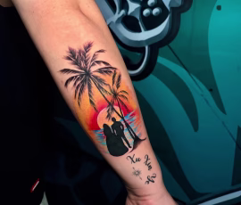 Contemporary tattoo of a color sunset scene with palm trees and a couple silhouette, on forearm