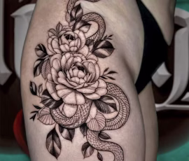 Floral tattoo of roses with a snake wrapped around them