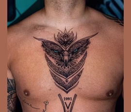 Geometric tattoo of an owl with dotwork detailing, on chest