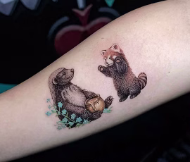 Micro realism tattoo of two animals playing, on forearm