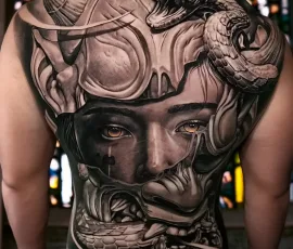 Healed black and grey back tattoo of a woman with goggles