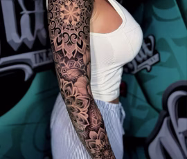 Contemporary tattoo sleeve with ornamental lace and dotwork patterns