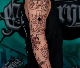 Sak Yant tattoo sleeve with traditional temple and sacred script designs