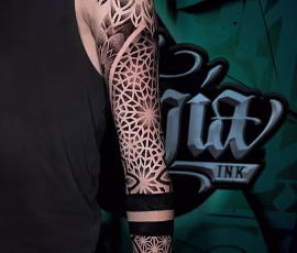 Geometric dotwork tattoo sleeve with fine stippled patterns, on arm