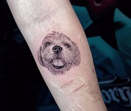Micro realism tattoo of a smiling fluffy dog's face