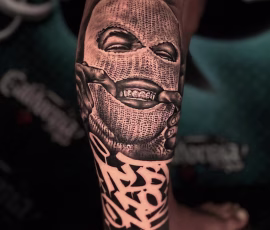 Chicano style tattoo in thailand of a masked figure