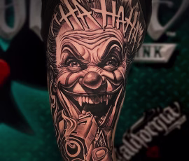Chicano style tattoo of a laughing clown