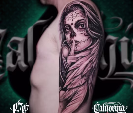 Chicano style tattoo of a Santa Muerte skull face